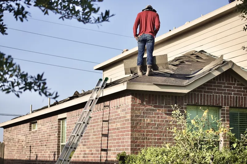 Professional roofer working on a residential roof in Little Havana